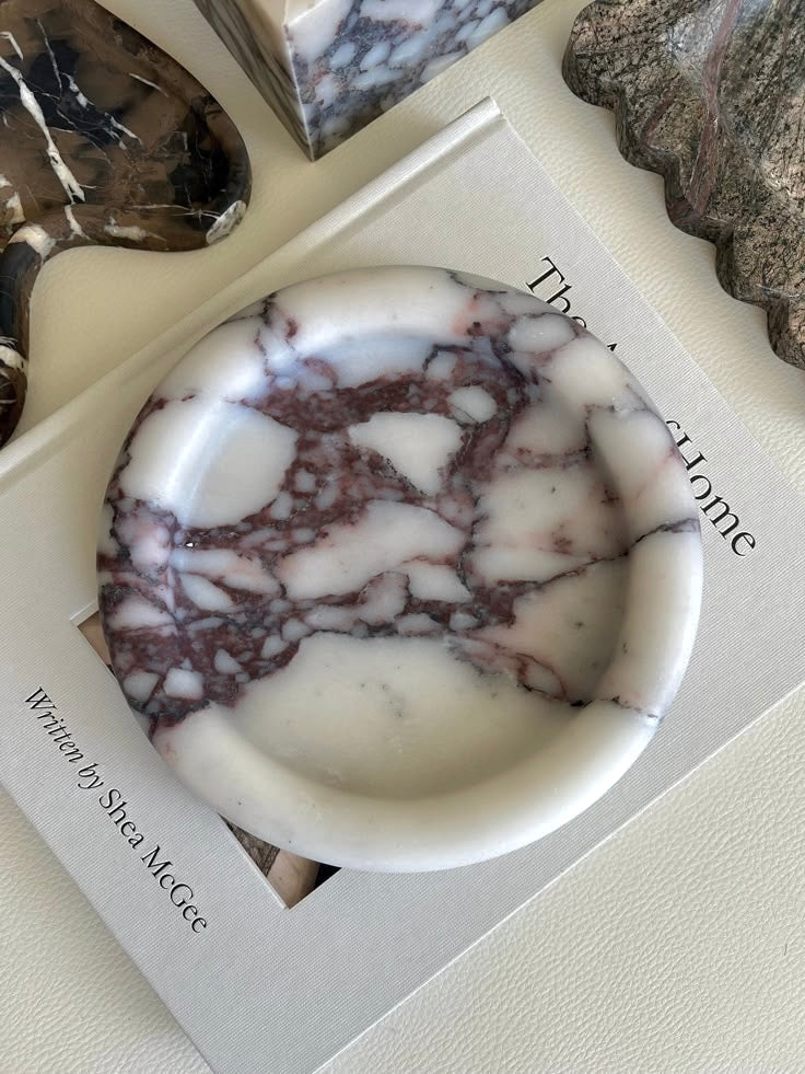 Marble-patterned soap in a decorative box with text on a neutral background