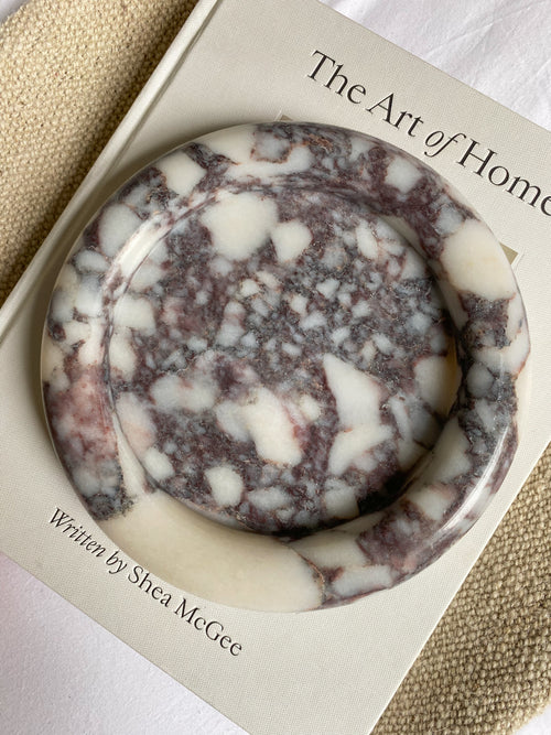 Marble-patterned tray on a book titled 'The Art of Home'