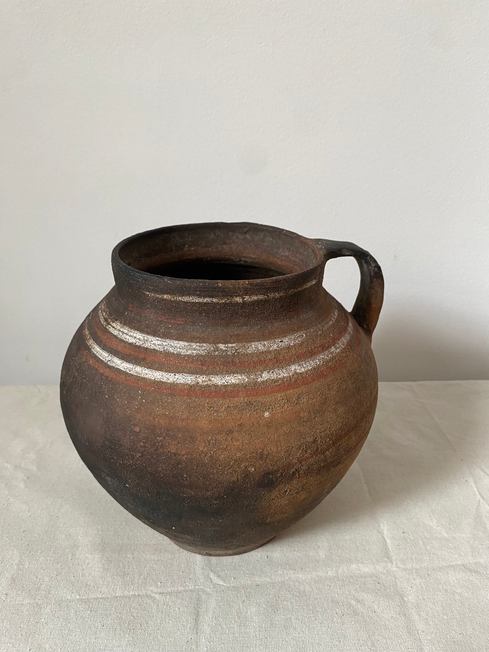 Brown ceramic vase on a light gray background