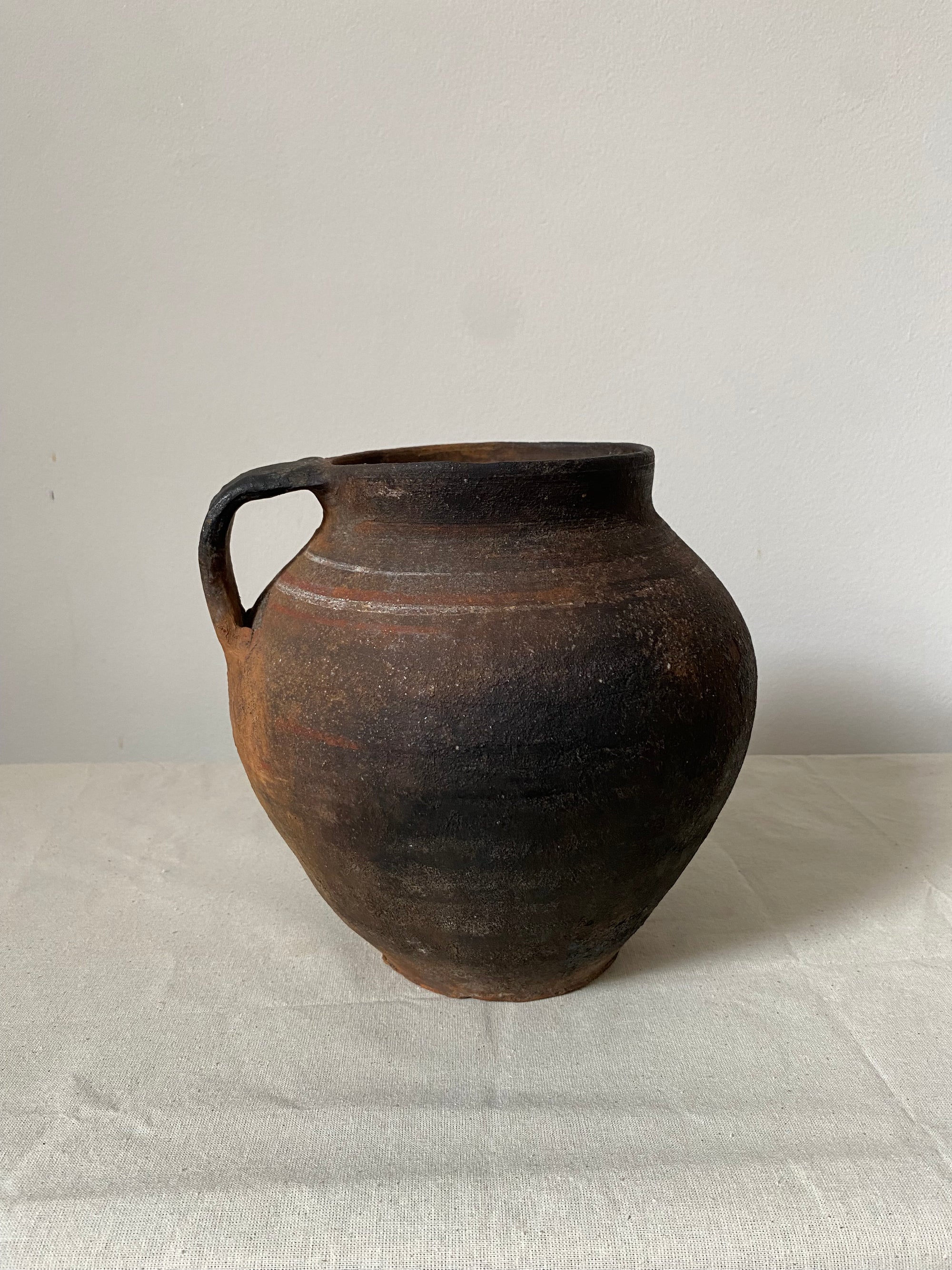 Black ceramic cup on a light gray background