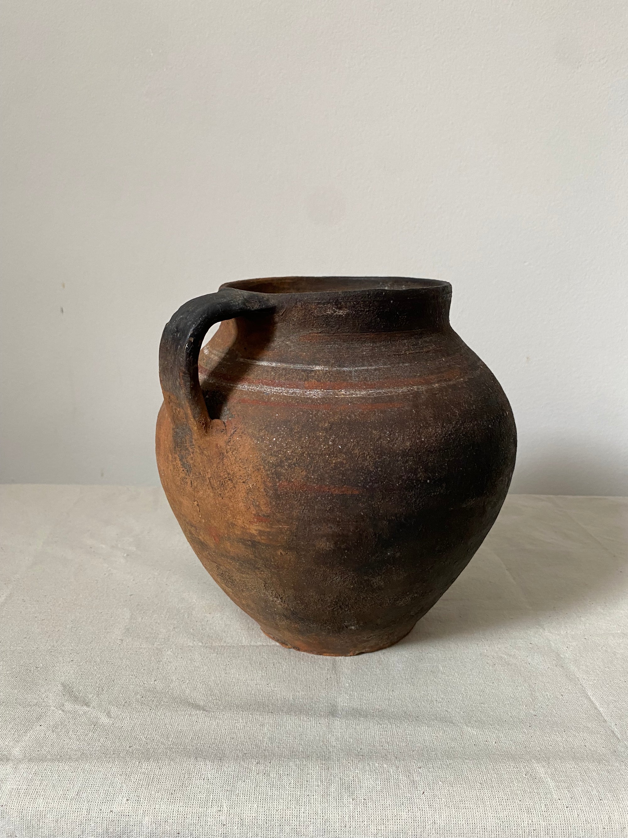 Brown ceramic vase on a light gray background