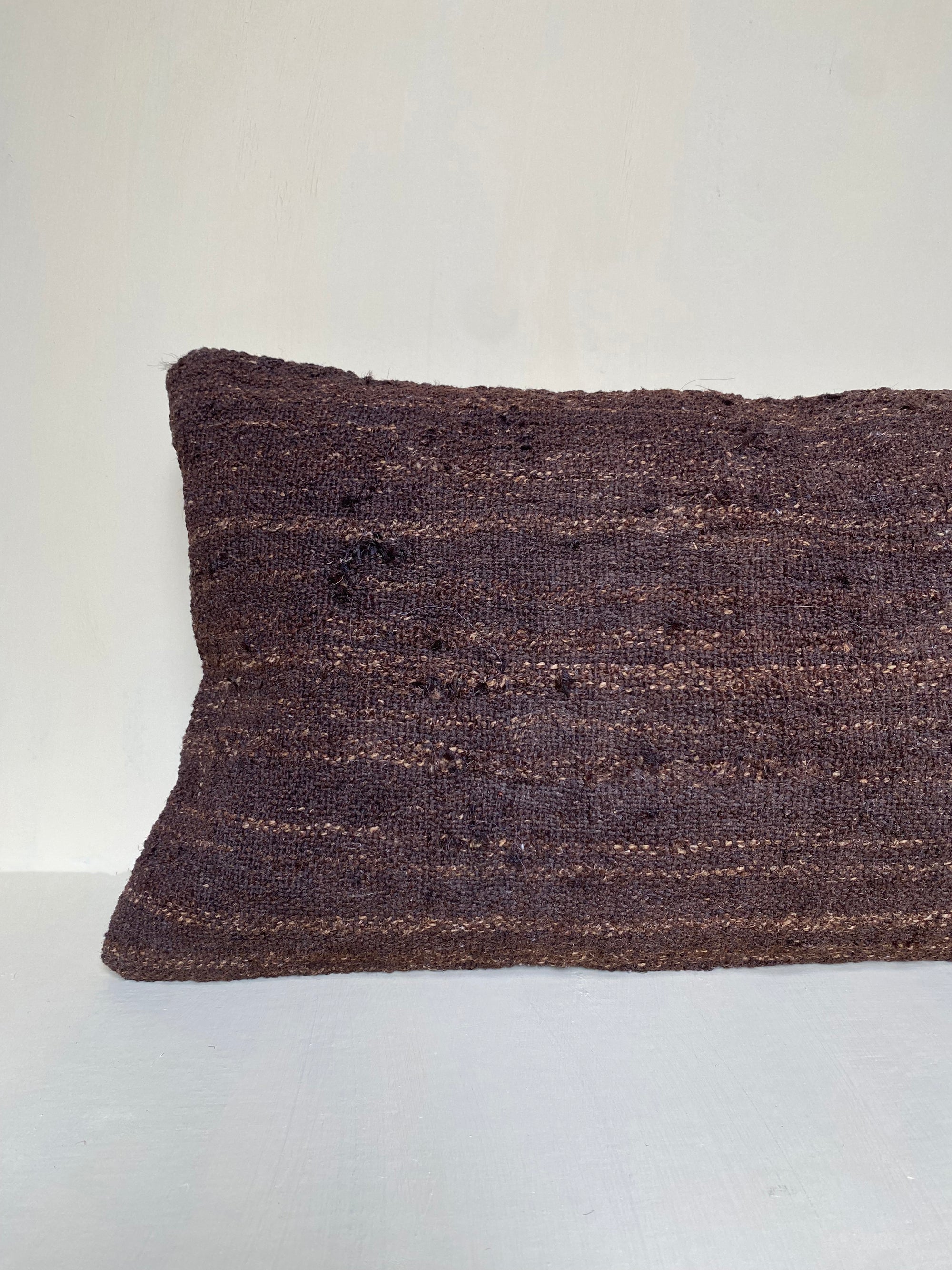 Handwoven vintage brown Turkish kilim cushion cover with rich earthy tones, made from Turkish wool – ideal for rustic living rooms and layered sofa styling.