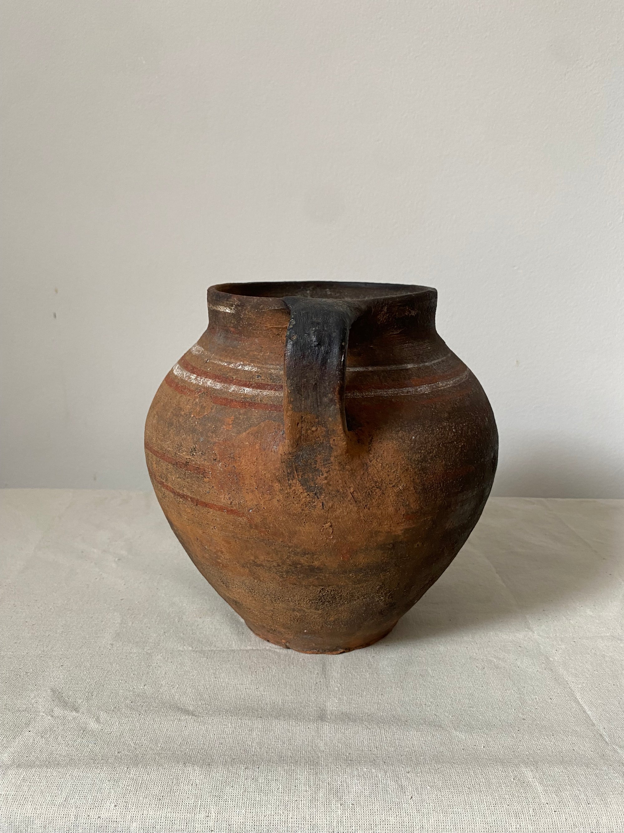 Brown ceramic vase on a light gray background