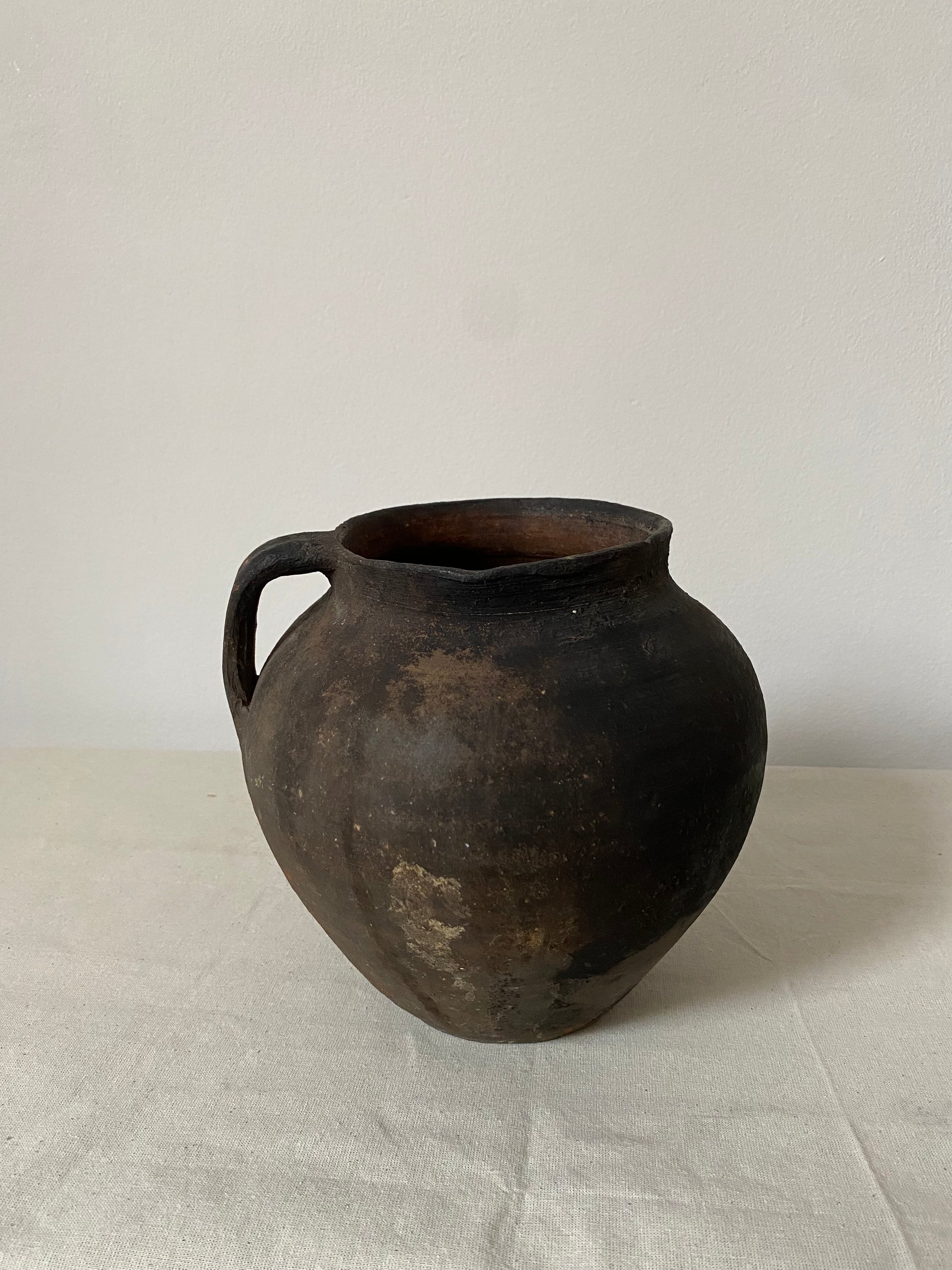 Black ceramic vase on a light gray background