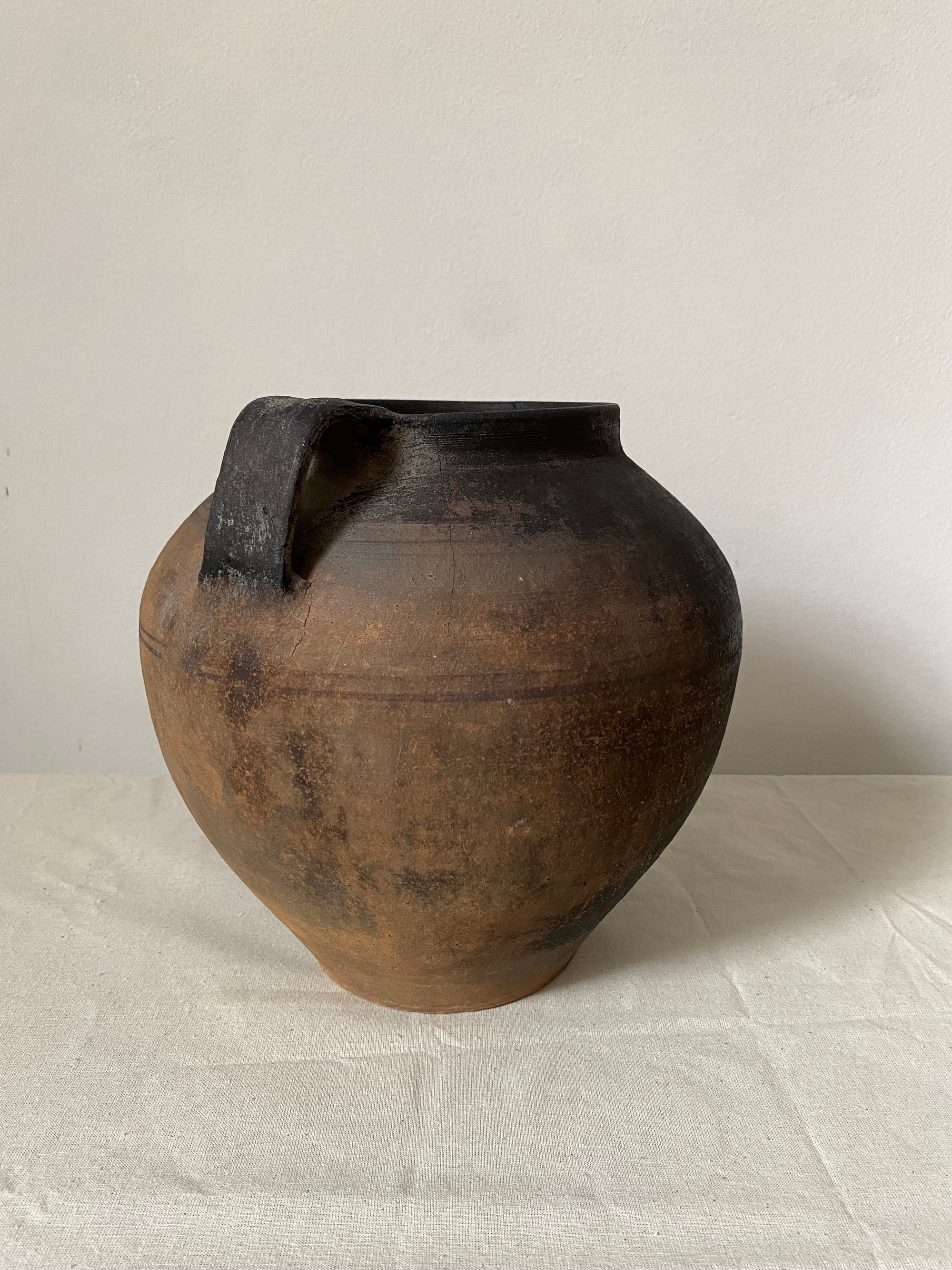 Brown ceramic vase on a light gray surface