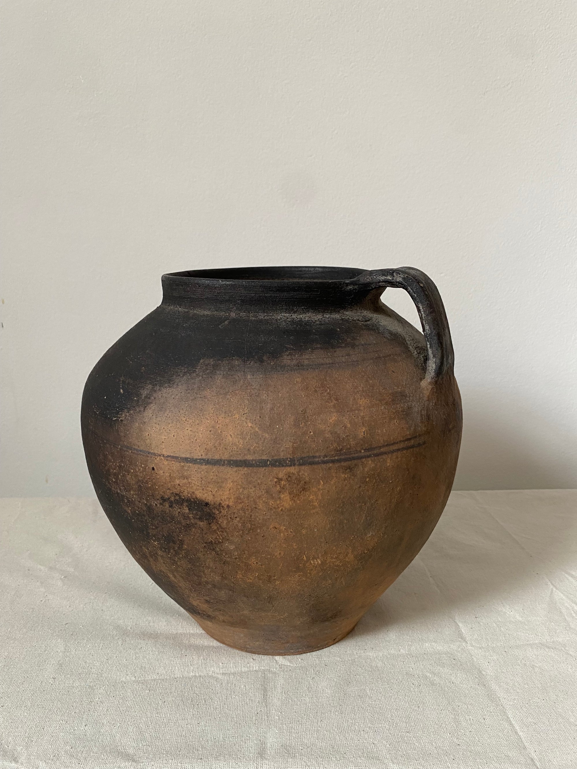 Black ceramic vase on a white background